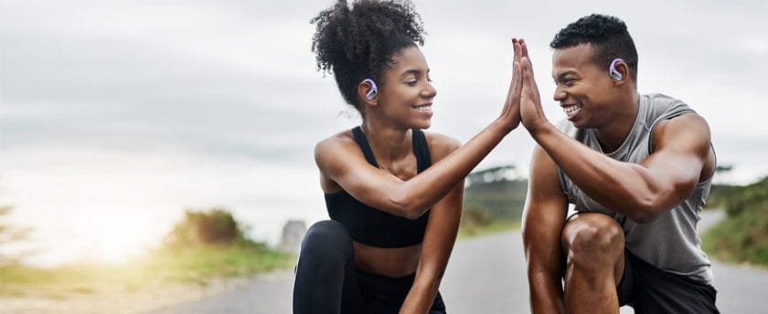 Two people giving each other a high-five during a workout